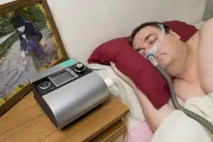 Man with Sleep Apnoea use a Tool For anti Snoring